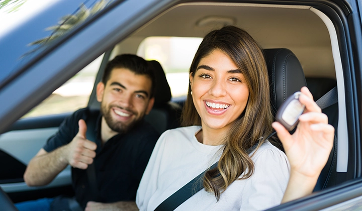 couple smiling in new car