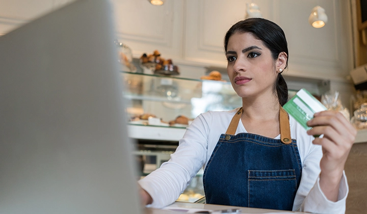 business owner with credit card on a laptop