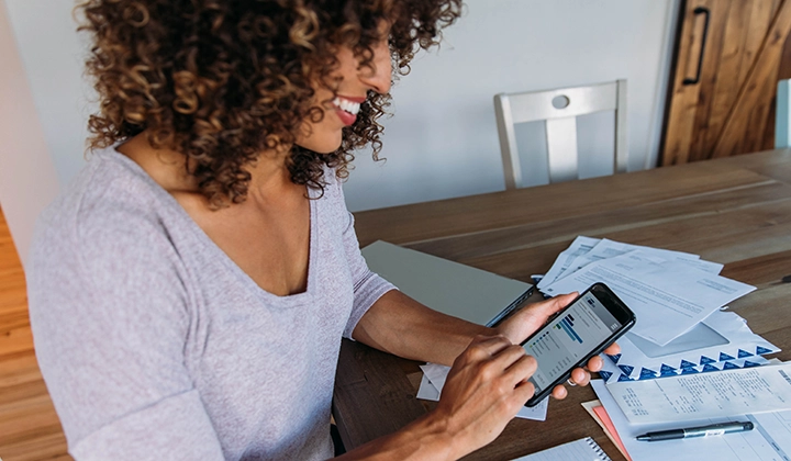 woman on mobile phone at table