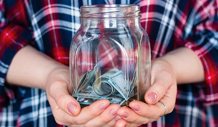 person holding donation jar